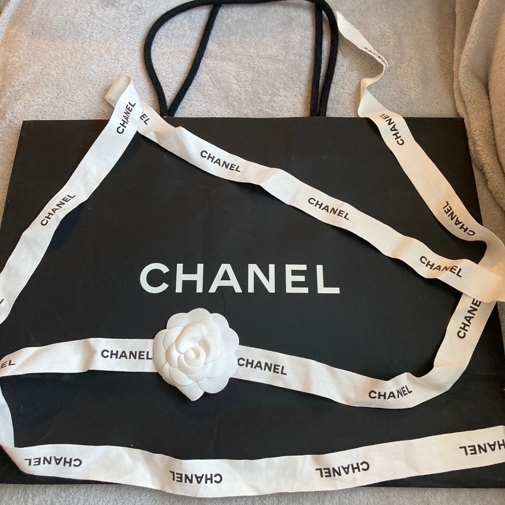 Chanel shopping paper bag with ribbon and flower